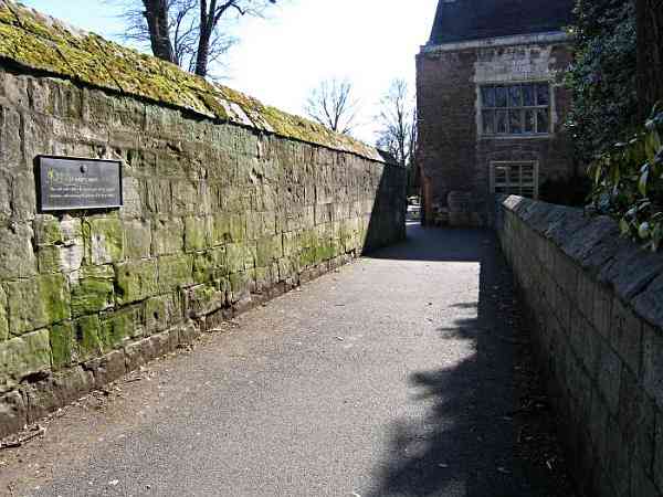 Looking along the lane and the medieval abbey wall towards the Museum Gardens.