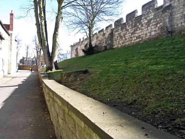 Looking along the lane and the medieval wall towards Exhibition Square and Bootham Bar..